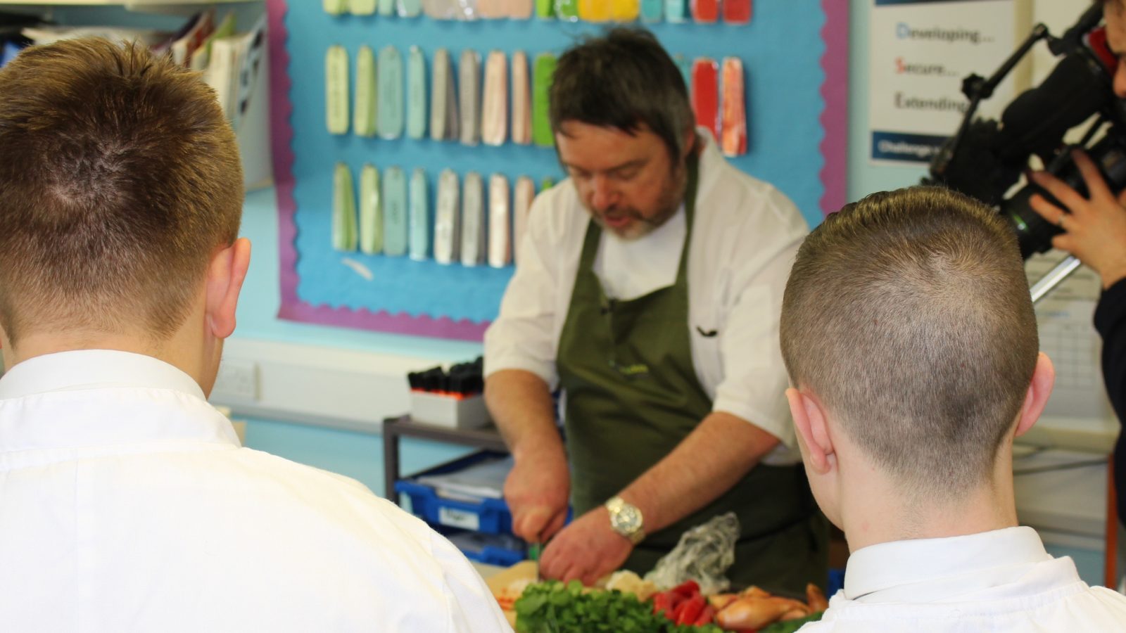 Adrian Kirikmaa teaching children basic cooking skills