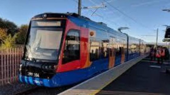 Blue, red and yellow train stopped at station with blue sky above