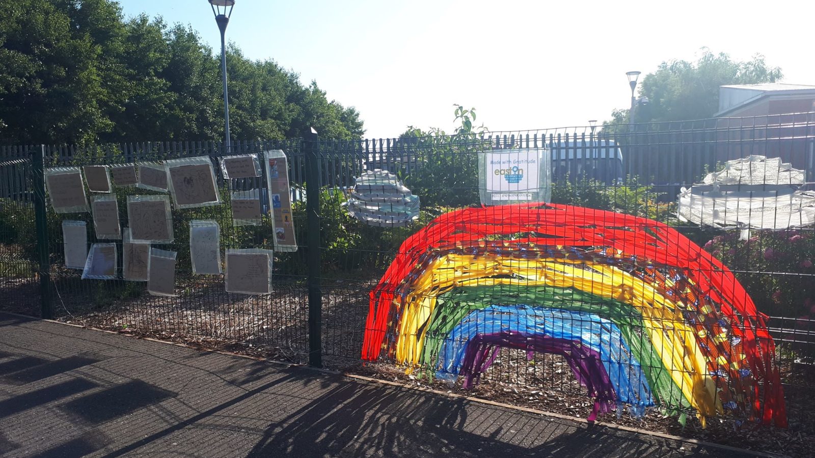 Photo: Rainbow and childrens' drawings on wall of Easton Community Children's Centre