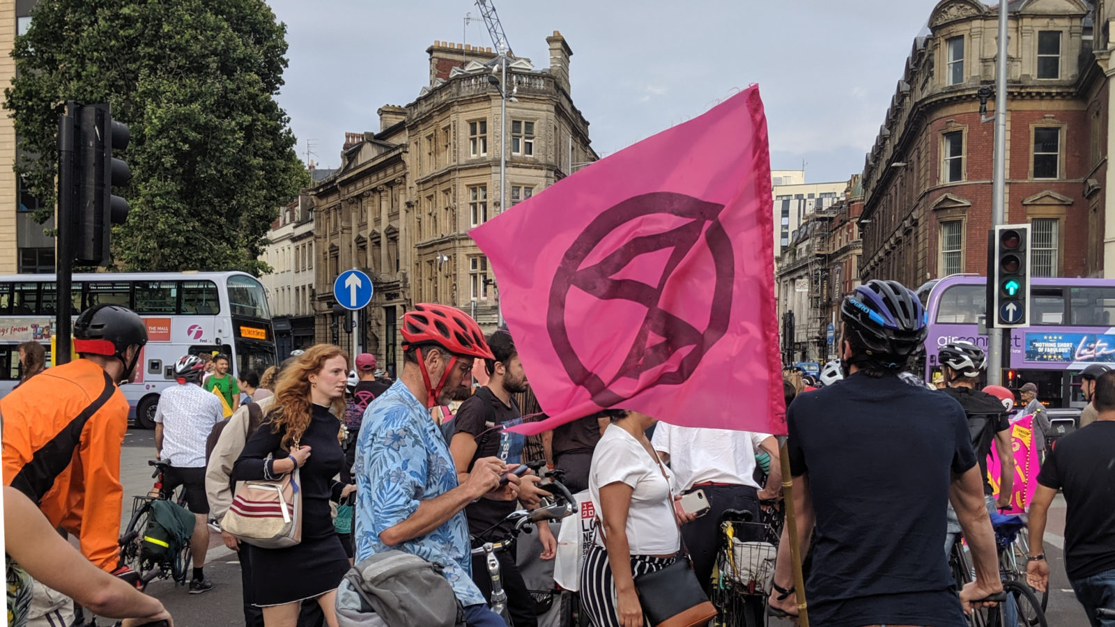 Photo: Extinction Rebellion flag flown in The Centre, Bristol, amongst cyclists partaking in a critical mass protest ride.