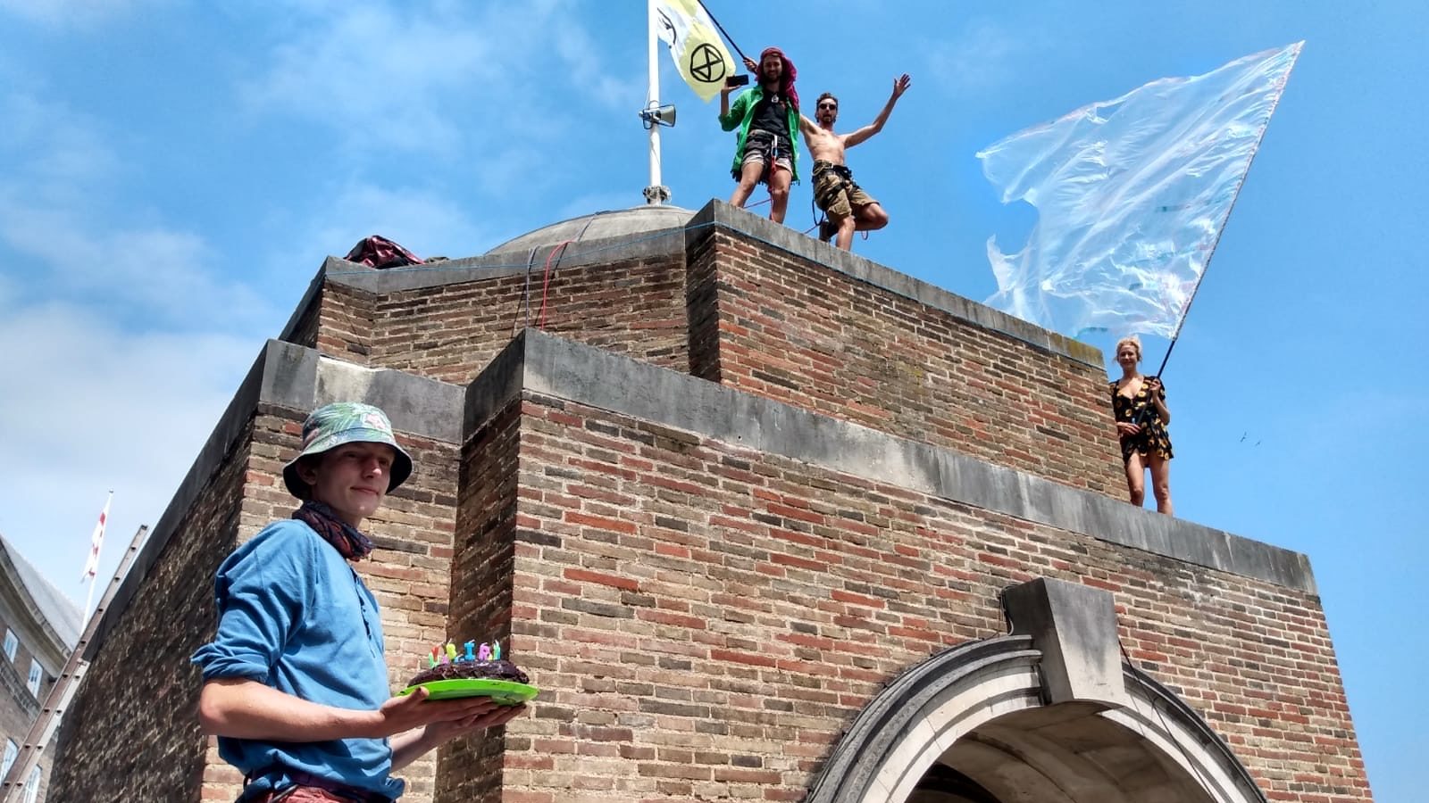 Photo: Extinction Rebellion posters on City Hall roof with cake