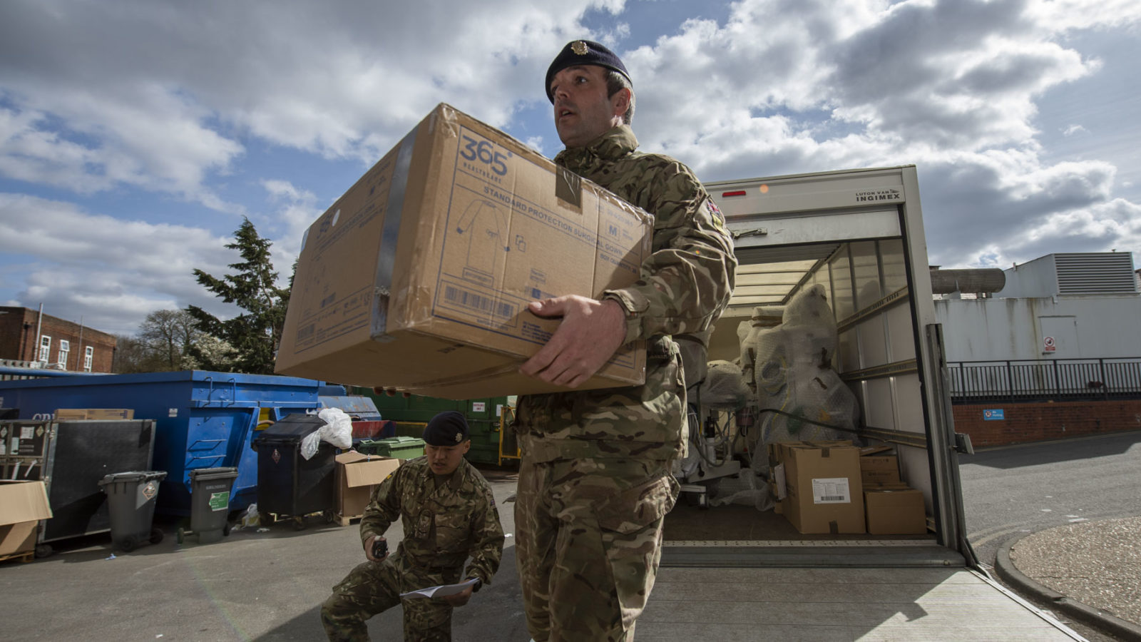 Photo: Soldier delivering box of PPE.