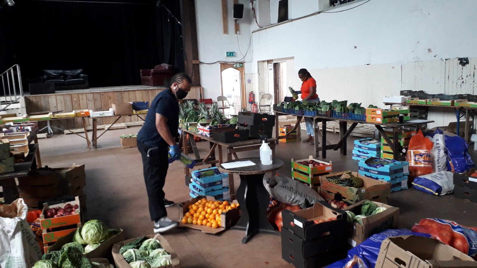 volunteers pack veg boxes in All Hallows Hall in Easton