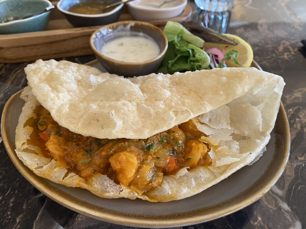 The prawn puri starter - prawns in a sauce enveloped in a soft fried puri bread