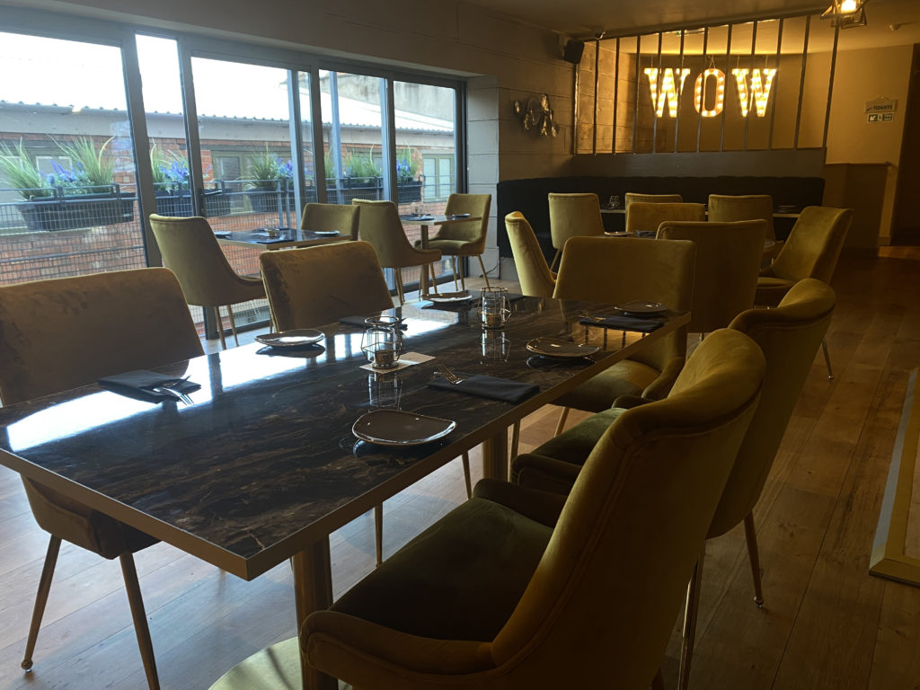 Inside the dining room of Haveli The Yard looking out at large windows
