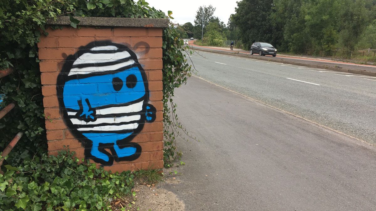 Mr Bump painted on a wall by the side of a road