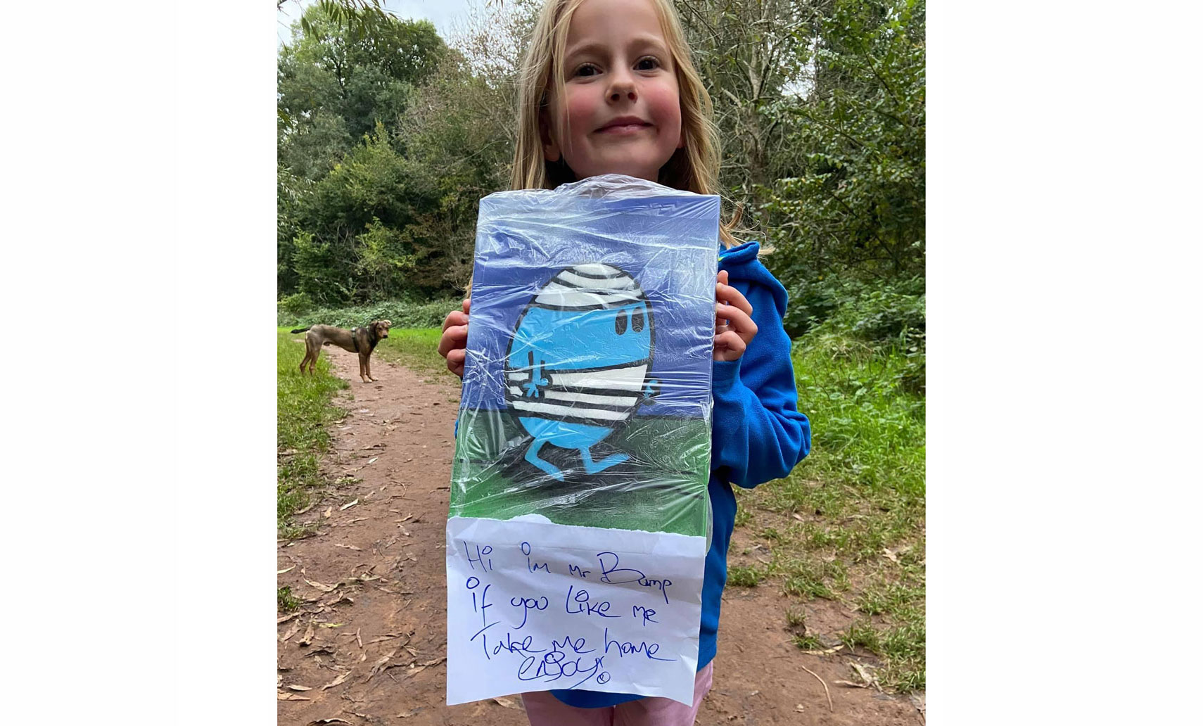 A girl holds up a picture of Mr Bump