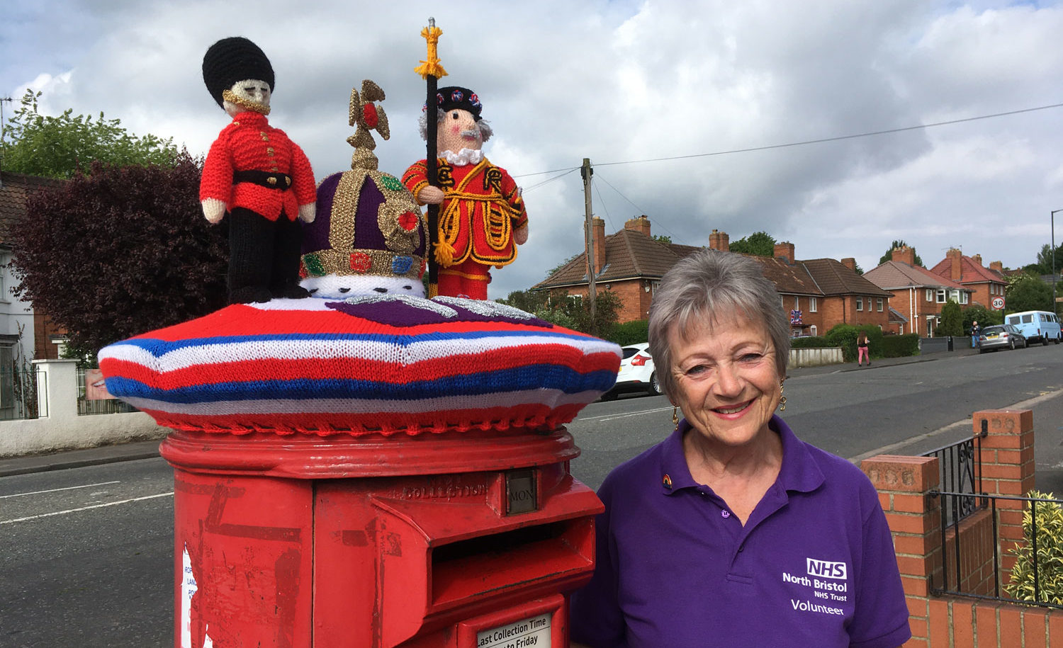 Judy stands next to her post box topper