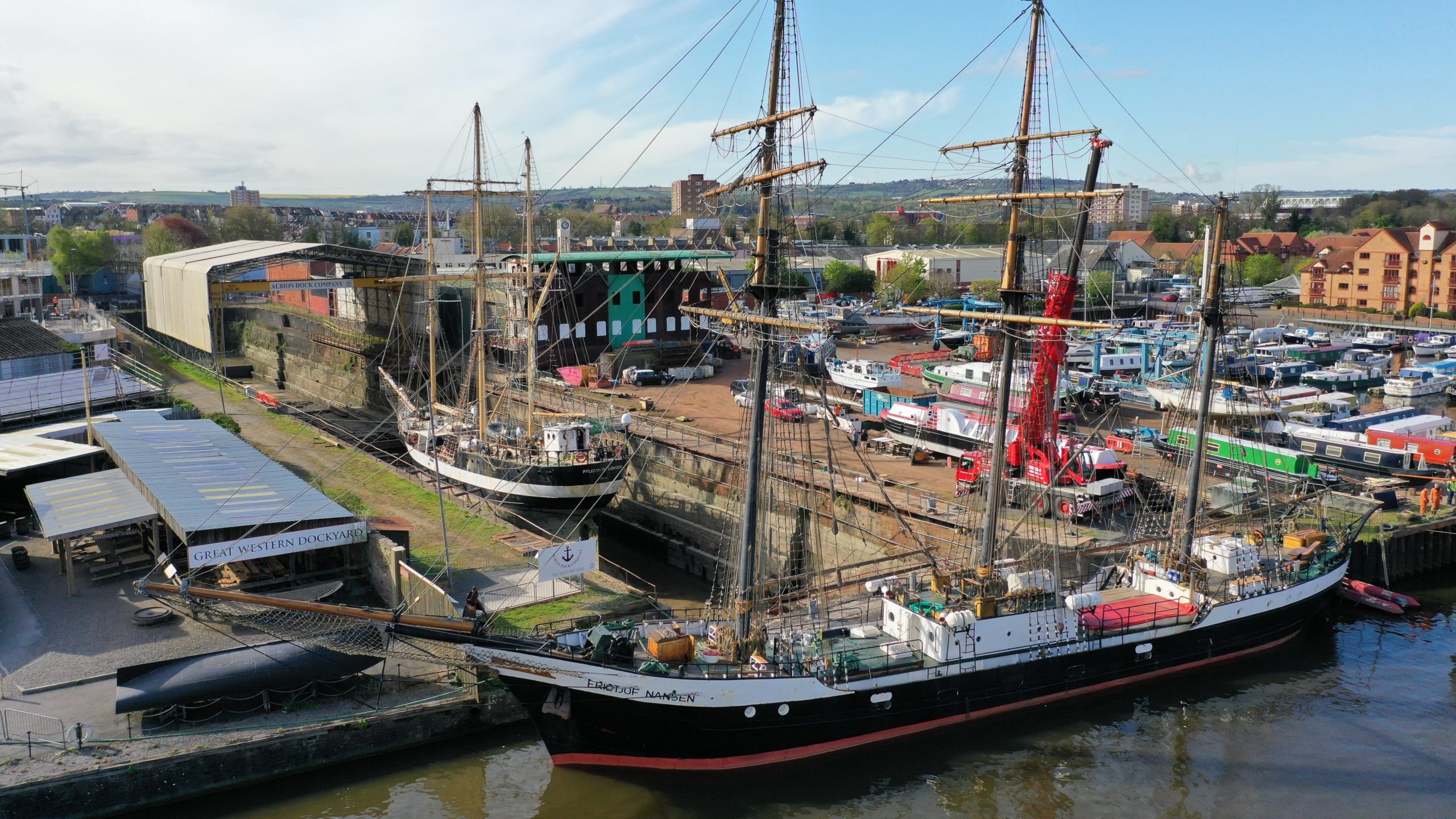 Two tall ships in harbour taken from above by a drone.