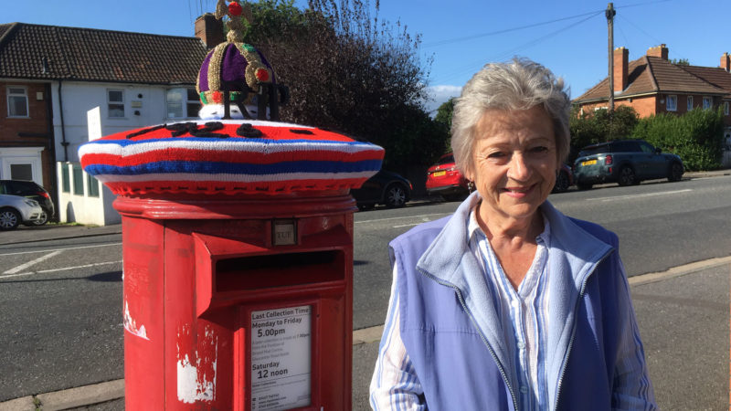 Judy stands next to her post box topper
