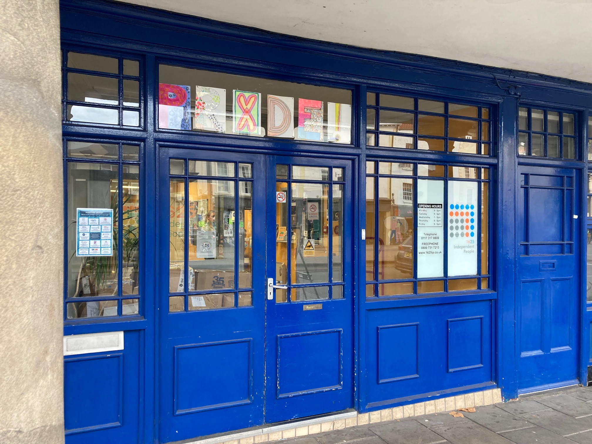 An office in Bristol painted dark blue with lots of windows