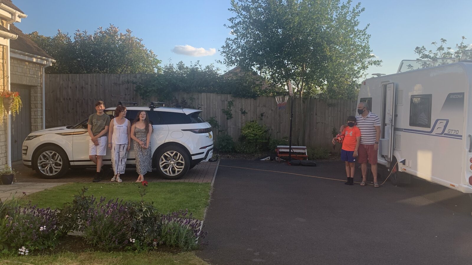 A family selfie, Lucy and her husband smile at the front of the group, with four children standing behind them also smiling. They are wrapped up warm.