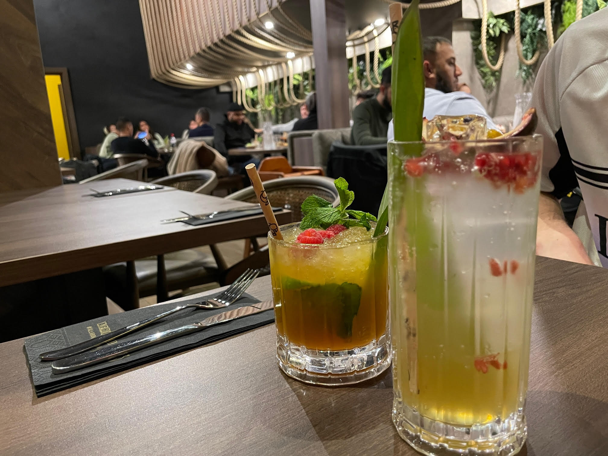 Two mocktails in Afrikana are colourful and garnished with banana leaves and fruit