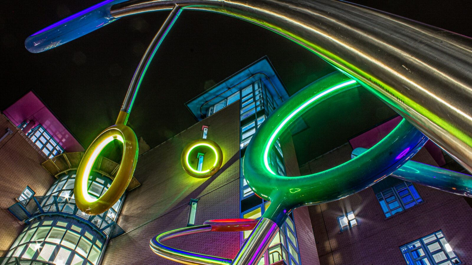 Lollipop Be-Bop sculpture outside Bristol Children's Hospital featuring hoops lit up yellow, green and blue