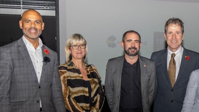 A group of four people stand in a row. They are Marvin Rees, Laura Aviles, Craig Cheney and Dan Norris.