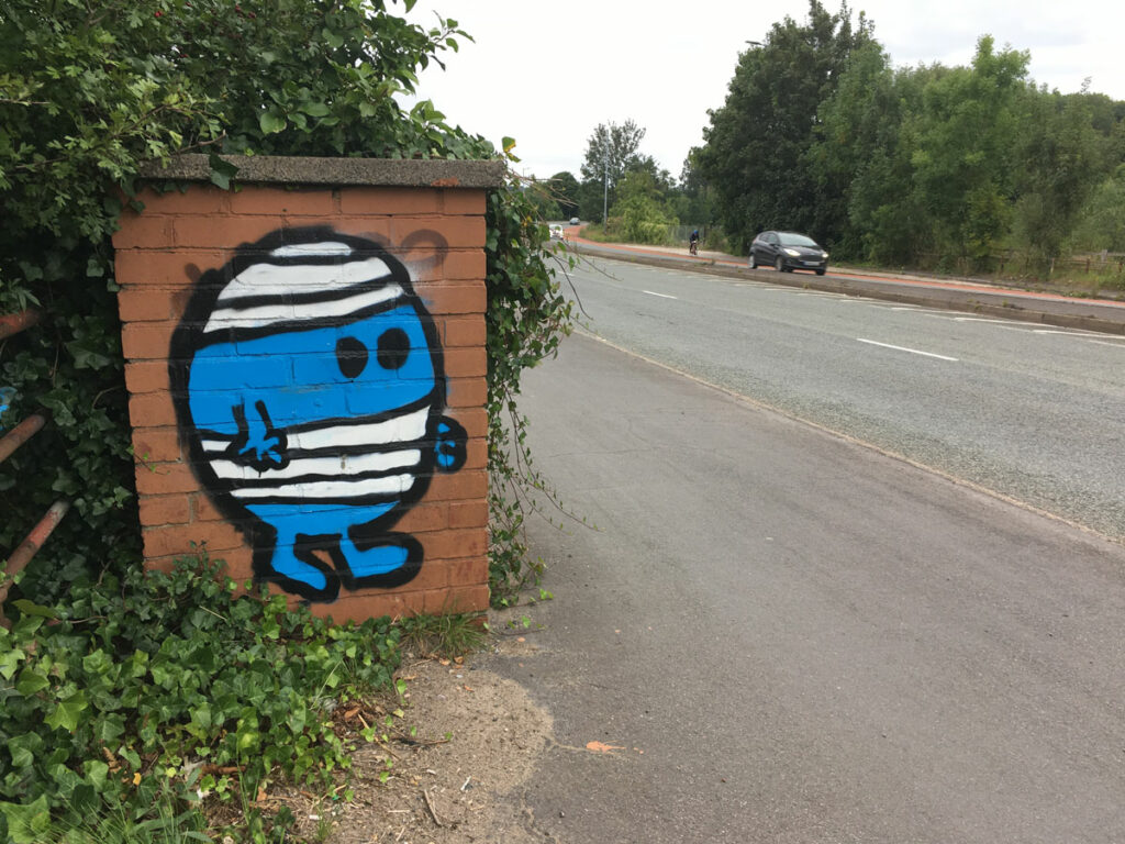 Image of Mr Bump painted on a small red brick wall