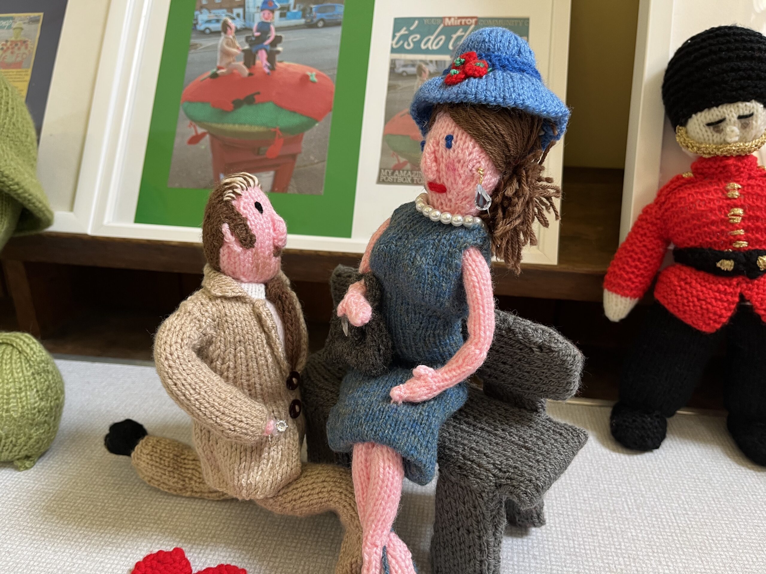 A knitted couple, the man is kneeling to propose marriage
