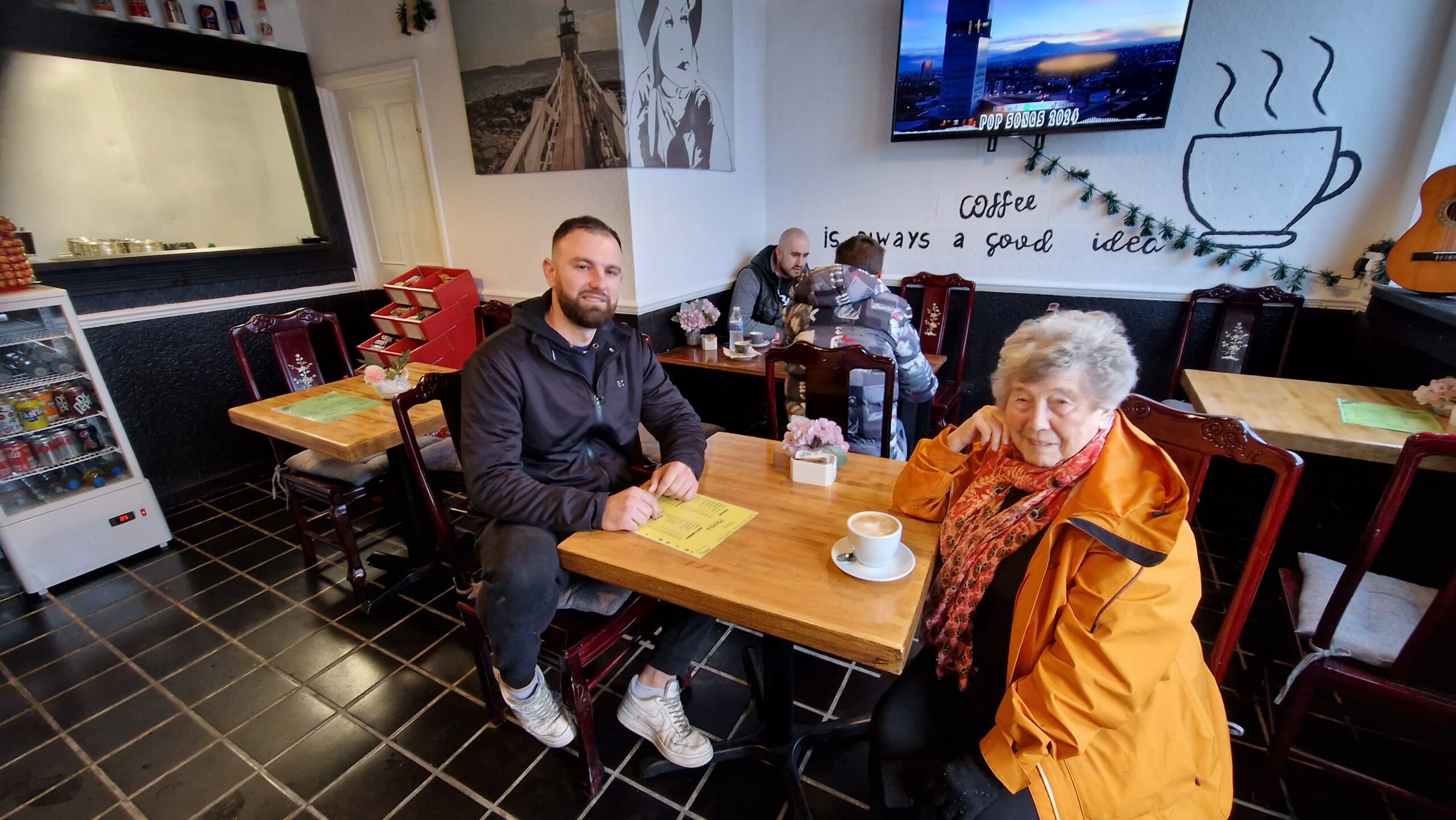 Coffee shop owner and local resident enjoy a cappuccino in the new Lockleaze Coffee Shop