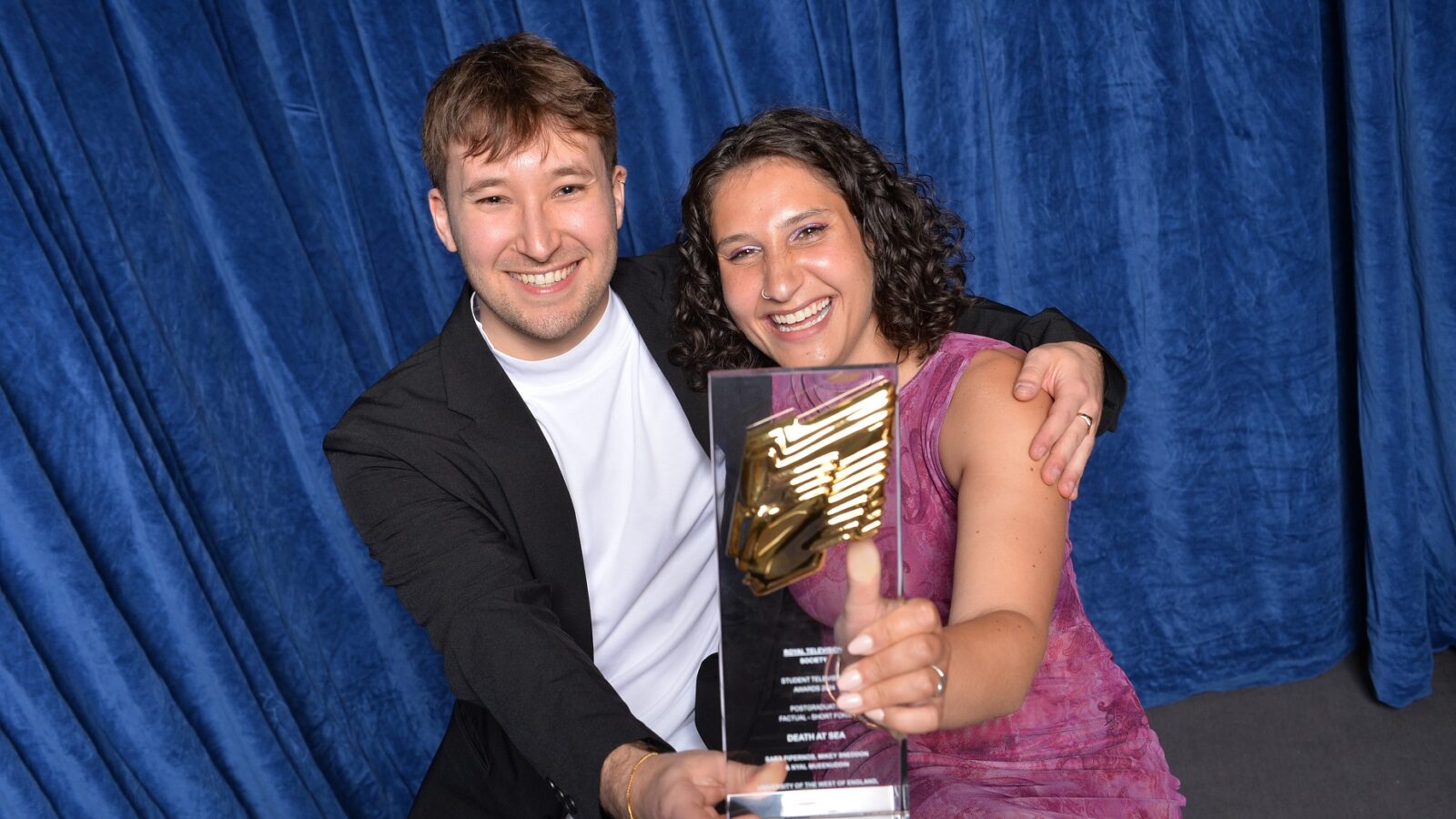 Mikey Sneddon and Sara Pipernos embracing and holding their National Royal Television Society Student Award