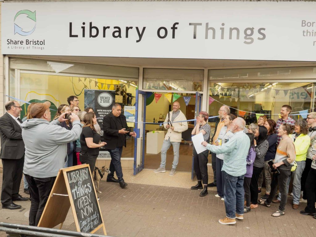 A man cuts a celabatory ribbon to unveil a new library of things in Bedminster