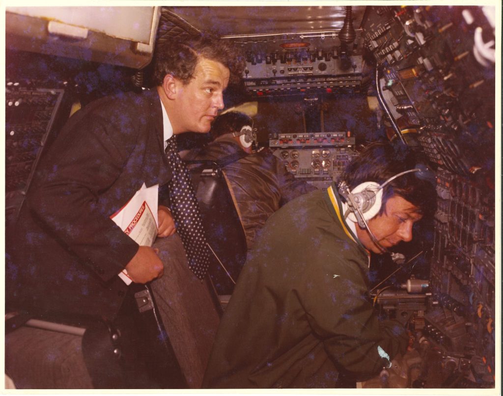Old photo showing Brian Watts in the cockpit of an aircraft, possibly Concorde