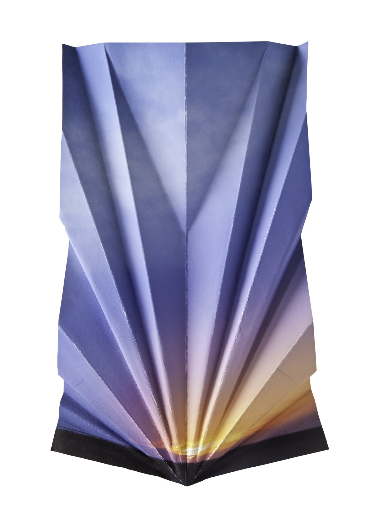 An image of a sunset and sky heavily editied to look like it has been folded akin to origami