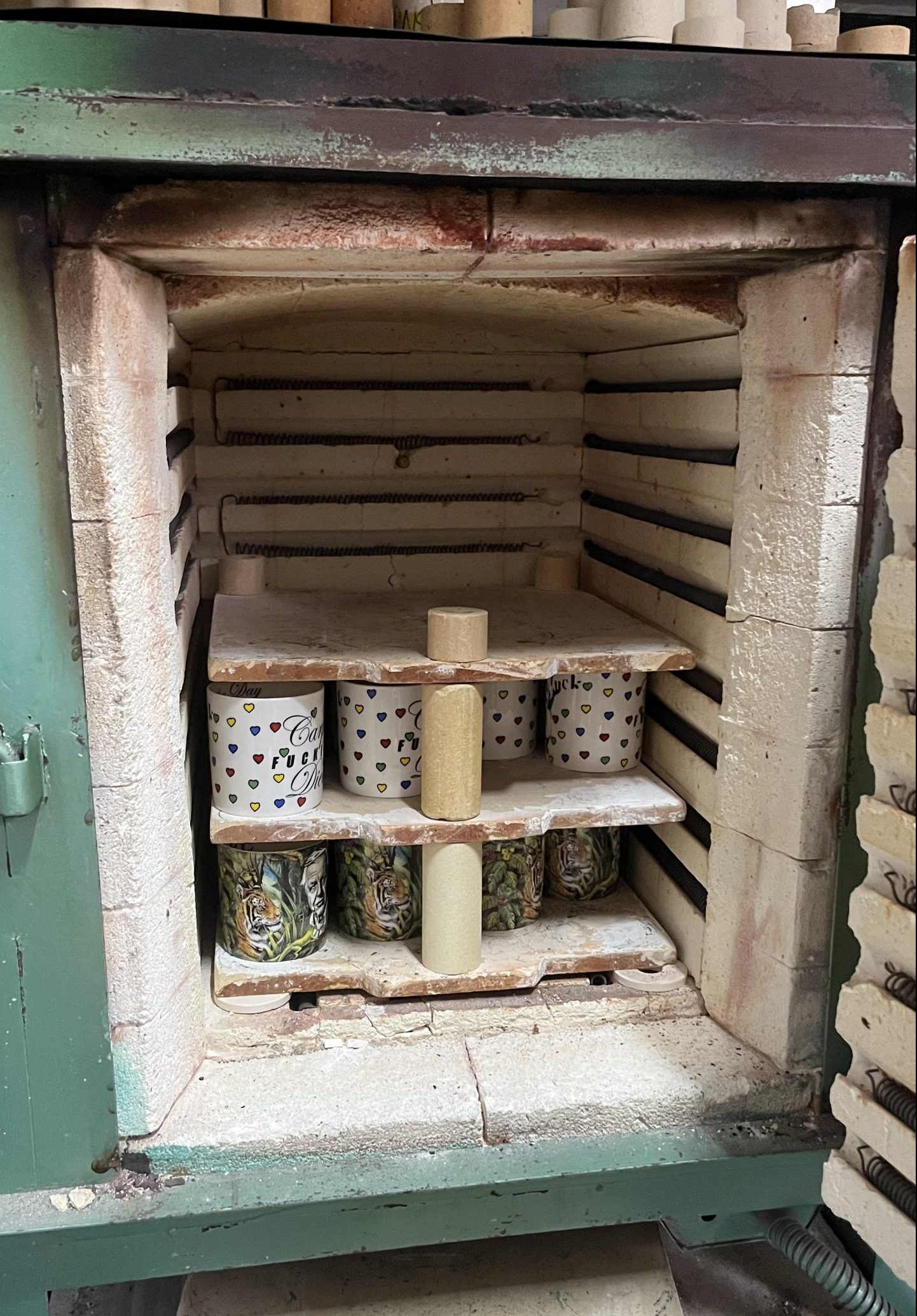 Mugs are stacked into a kiln ready for firing 