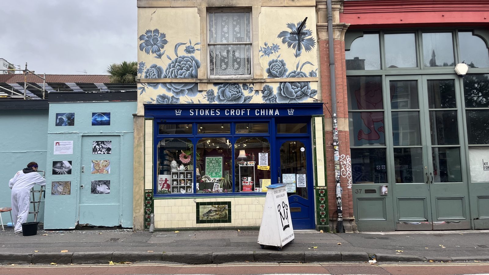 An outdoor exhibition being put up next to the shop Stokes Croft China