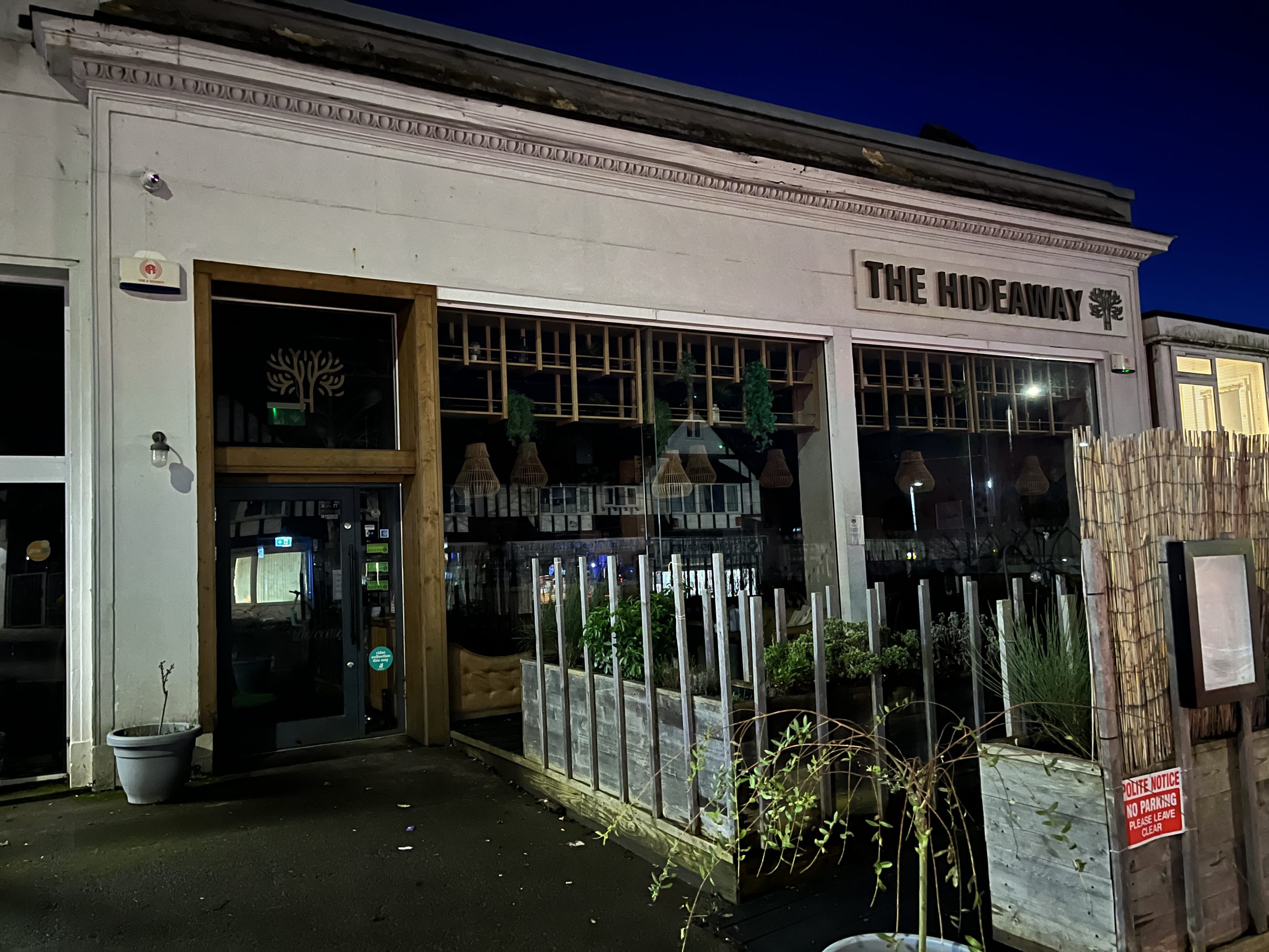 Exterior picture of a dark,closed cafe, all the lights are off