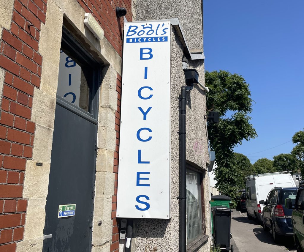A white sign that reads Bools Bicycles