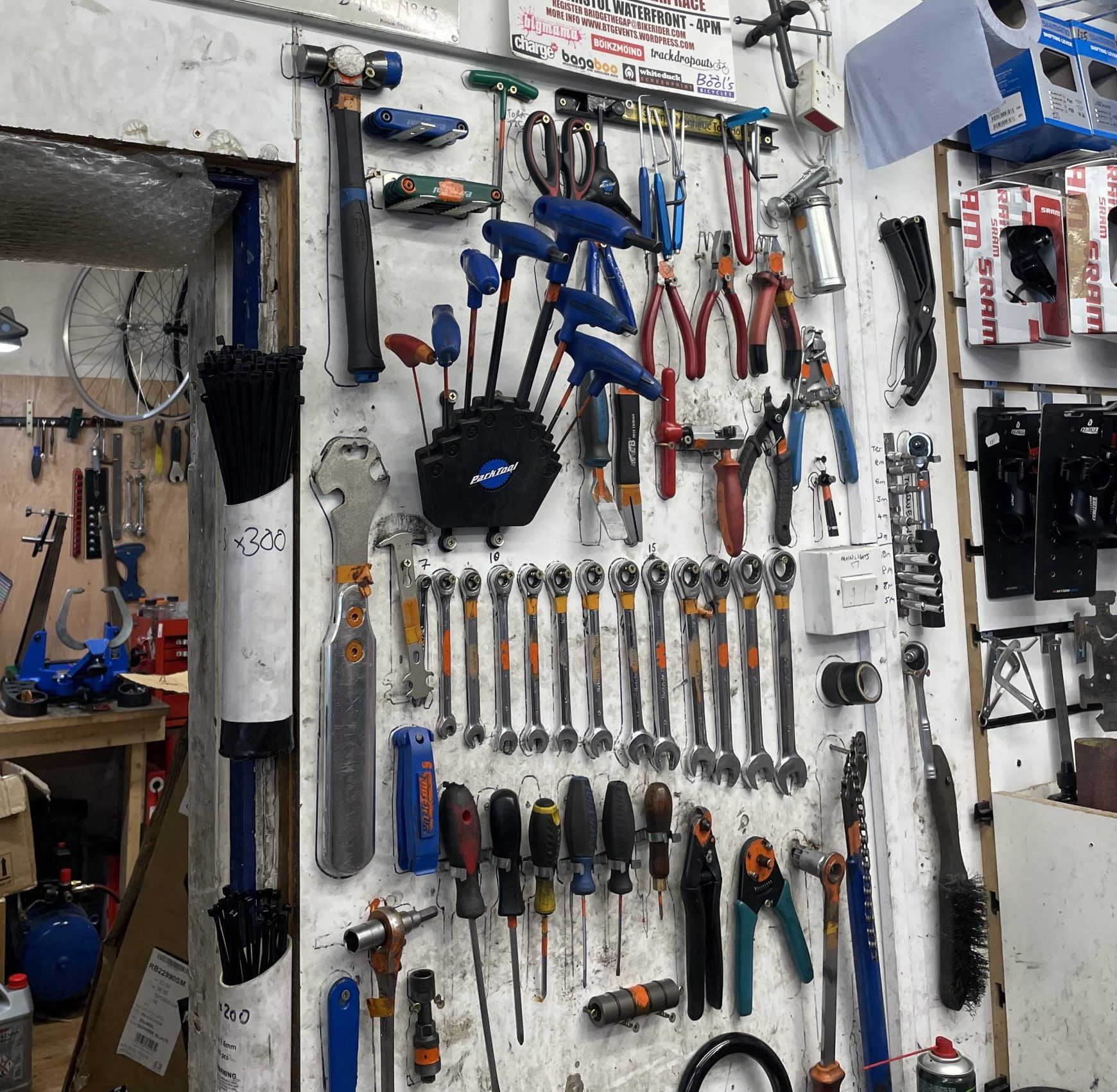 Rows of tools hang from a wall