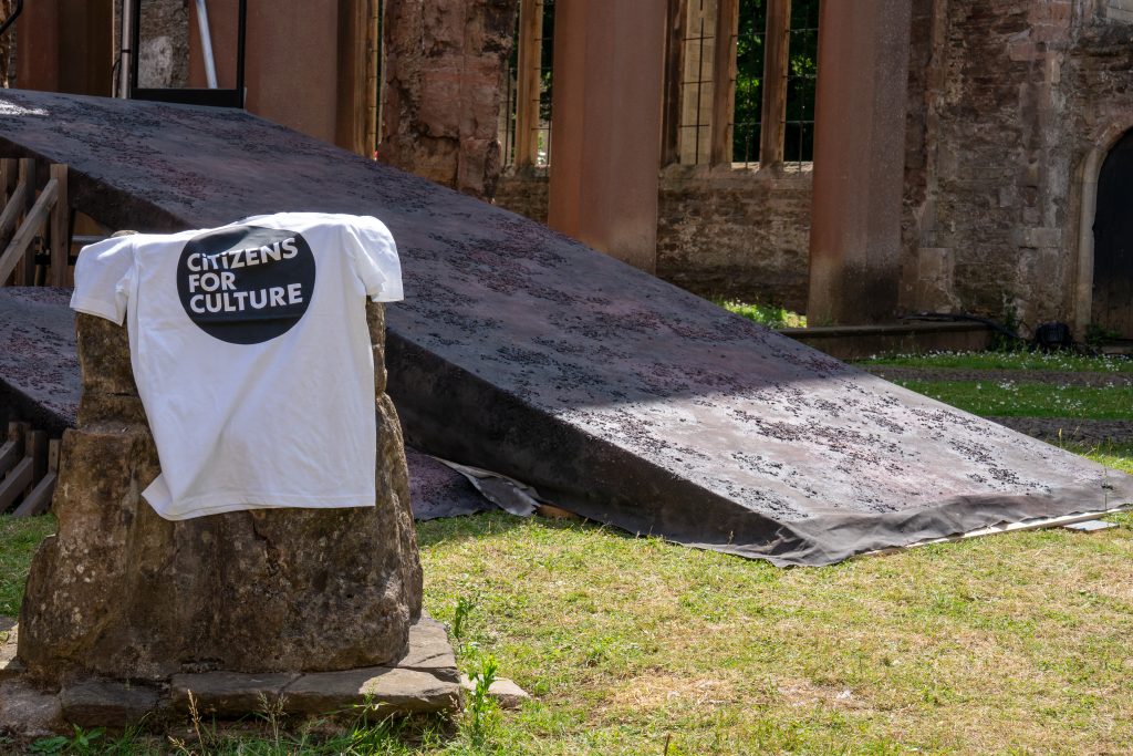 A Citizens for Culture t-shirt draped over a standing stone at Temple Church