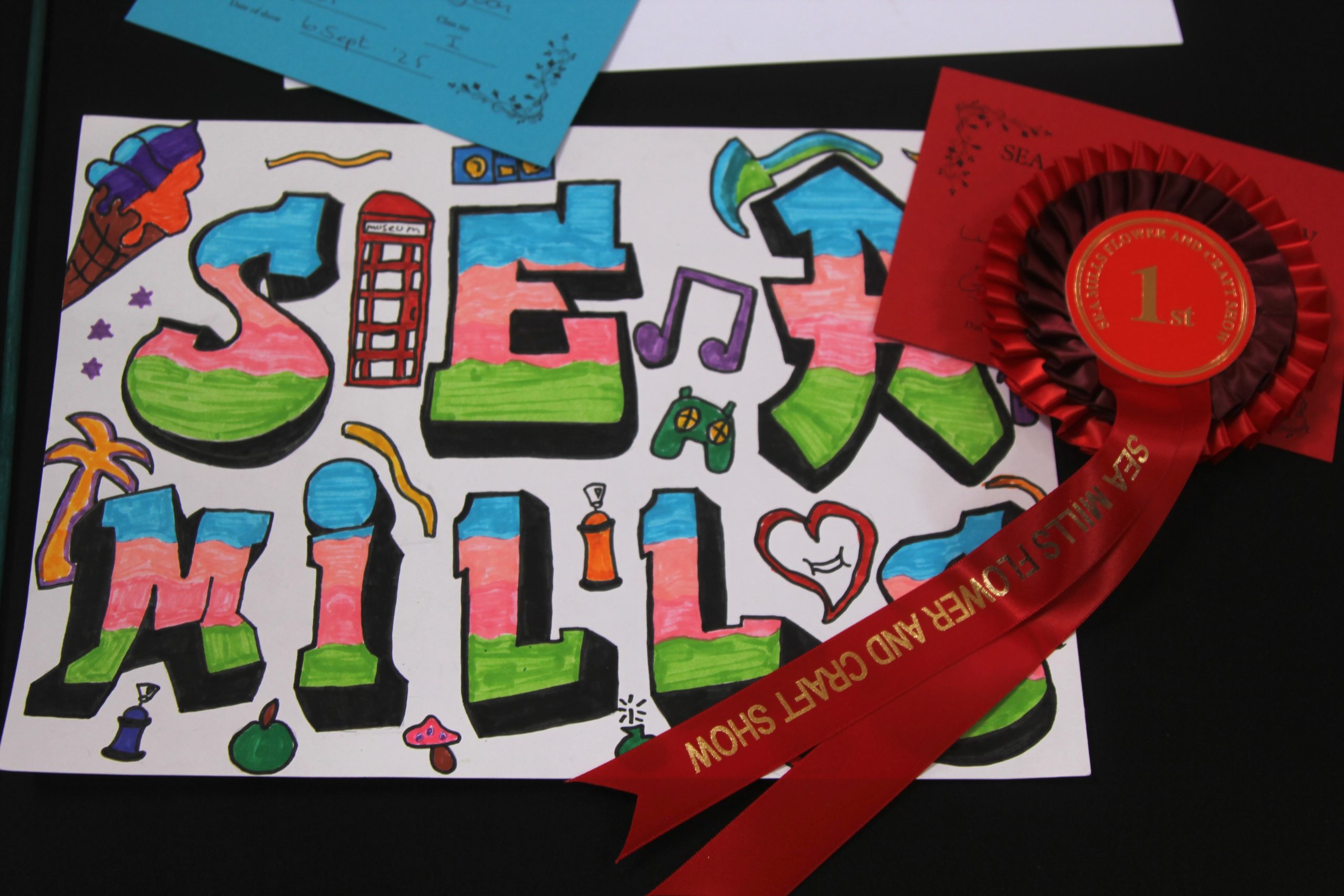 Graffitti drawing including the words Sea Mills and a red phone box