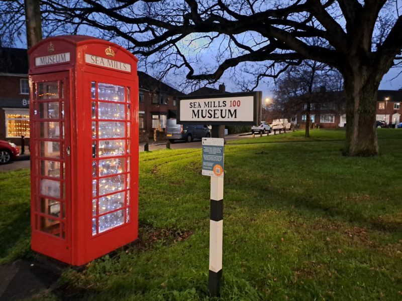 A phone box is lit upside with fairy lights