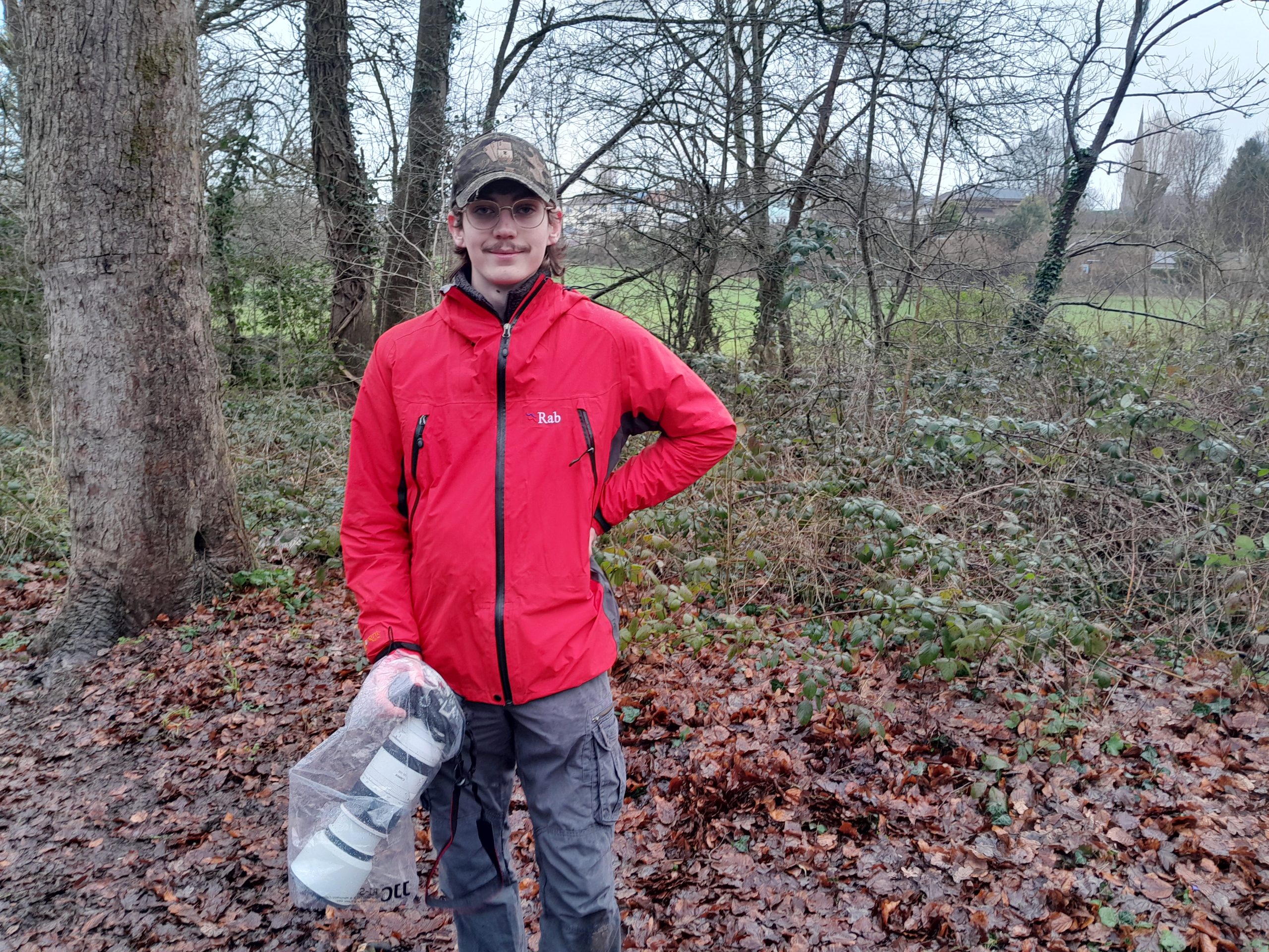 A young photgrapher holding his camera in Eastville Park
