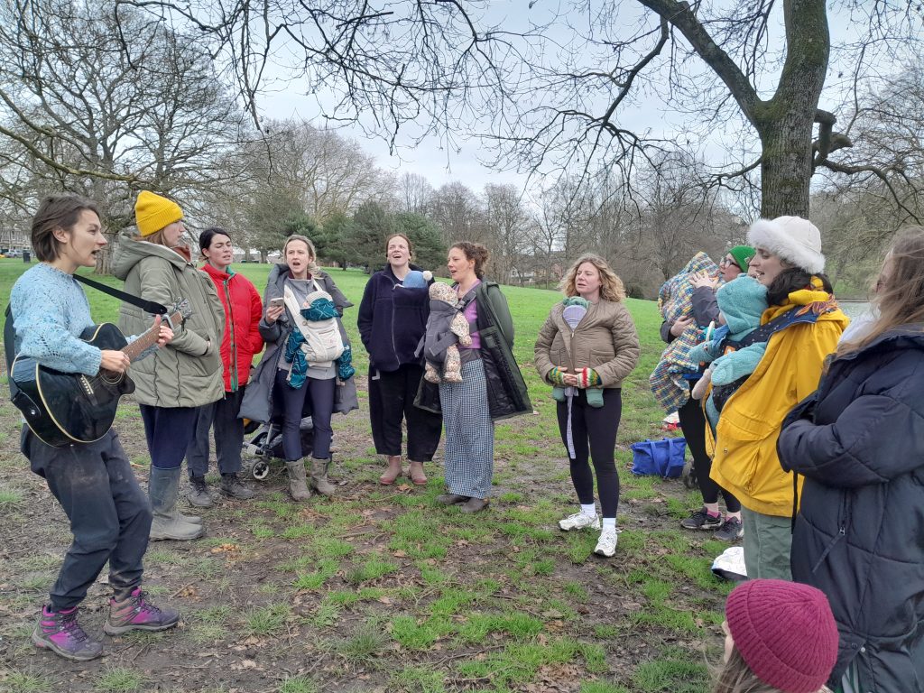 Bring Your Own Baby choir practice in park
