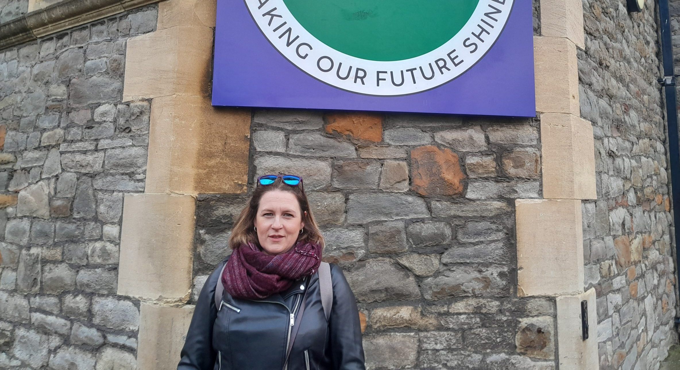 Local parent standing outside Summerhill Academy sign